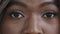 Extreme shot close-up female cropped face young african american woman looking at camera laser vision correction