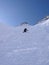 Extreme skier skiing a very steep north face ski descent in the Alps of Switzerland