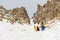 Extreme skiers climb to the top along the couloir between the rocks before the descent of the freeride backcountry