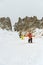 Extreme skiers climb to the top along the couloir between the rocks before the descent of the freeride backcountry