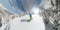 Extreme snowboarder riding and turning in powder snow in mountain wilderness