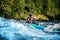 Extreme sport rafting whitewater kayaking. Guy in kayak sails mountain river