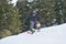 Extreme Sports Action: Snowboarder Soaring Through the Air on a Hillside Jump