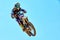 Extreme sports, motorcycle jumping. Motorcyclist makes an extreme jump against the sky.