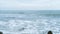 Extreme stormy weather on ocean coast, cloudy sky and blue color of sea water. High resolution real time video.