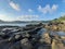 Extreme terrain from a rocky coast with a rock plateau and water puddles