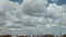 Extreme ultra wide view of the Toronto skyline on a day with puffy clouds.