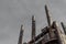 Extreme upward view of smokestacks on blast furnaces in an industrial steel mill, grey sky