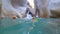 Extreme vacation with child, active swimming of son and mother tourists in life jackets in an underwater cave on the