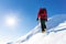 Extreme winter sports: climber at the top of a snowy peak in the