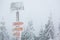 Extreme winter weather - hiking path sign covered with snow