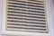 Extremely dirty and dusty white plastic ventilation air grille at home close up, harmful for health, house cleaning concept