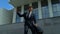 Extremely happy businessman dancing outdoors near office building, success