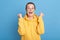 Extremely happy Caucasian woman in yellow hoodie with Ukrainian flag on cheeks, hearing news about Ukraine victory, stop war,