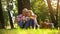 Extremely happy old couple resting on grass, holding apples and hugging, picnic