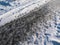 Extremely slippery footpath covered with melting snow and frozen ice