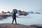 Extreming standing on the edge. Touristic man raised his hands up on the beautiful daylight mountains full of fog