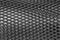 Exture of cambered metal perforated netted sheet with lighting effect.Grunge netted metal grill texture.