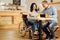 Exuberant man and disabled woman working from a cafe