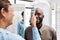 Eye exam, eyewear and an optometrist checking happy young male eyes with optic medical equipment. African man getting