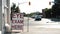 eye exam here writing text caption sandwich board sign in front of store