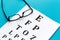 Eye examination. Eyesight test chart and glasses on blue background