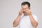 Eye irritation concept : Portrait of Asian man in posture of eye tired,  irritation or problem about his eye. Studio shot isolated