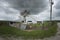 Eye-level gloomy shot of an old white barn on a cloudy day