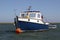 Eye-level shot of a blue and white motorboat in the sea