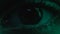 Eye of man driving through night city, flashing lights reflection, close up