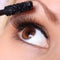 Eye and mascara brush. beautiful woman brown eye