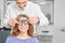 Eye specialist examining eyesight of woman.