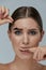 Eyebrow cosmetics. Woman taking off brow gel tint from eyebrow