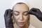 Eyebrow tattooing .Permanent eyebrow makeup master applies the contour with