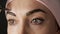 Eyebrows care. Attractive woman getting her eyebrows threaded. Close-up.