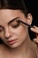 Eyebrows Contouring. Beautiful Woman With Brown Eyebrow Pencil