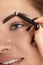 Eyebrows shaping. Beauty young woman with brow pencil