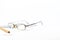 Eyeglass and pencil on business graphs on white background, space for text, focus on the eyeglass,