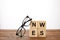 eyeglasses and alphabet cubes making word news on wooden surface, on white background