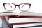 Eyeglasses on book stacks