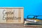 Eyeglasses, books and wooden board written with CAPITAL EXPENDITURE