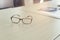 eyeglasses, calculator and business document, vintage tone