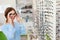 Eyeglasses Store. Woman Choosing Glasses For Eyesight Correction