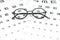 Eyeglasses and visual acuity chart in white background