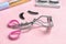 Eyelash curler on color background