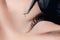 Eyelash extension procedure. Master tweezers black fake long lashes beautiful female eyes