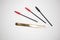 Eyelash extension tools, golden tweezers and red-black brushes