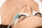 Eyelashes extensions. Fake eyelashes. Eyelash extension procedure.Close up portrait of woman eye with long eyelashes