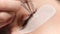 Eyelashes extensions. Fake eyelashes. Eyelash extension procedure.Close up portrait of woman eye with long eyelashes