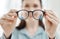 Eyes, vision and glasses with the hands of a woman optometrist holding spectacles during an eye test or exam. Frame
